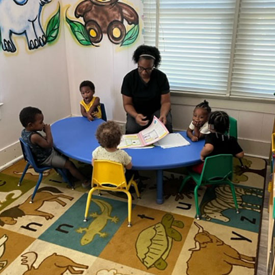 Small children learning at a table.